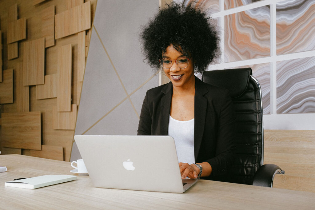 female business student sat at computer