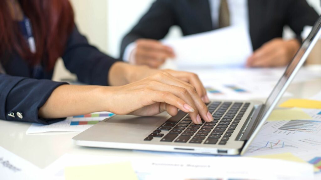 hands typing on keyboard