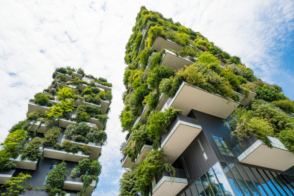 green sustainable building with moss on the outside of a skyscraper